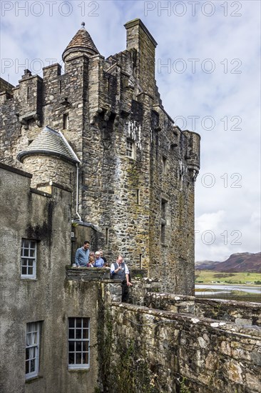 Guide with tourists in the Eilean Donan Castle