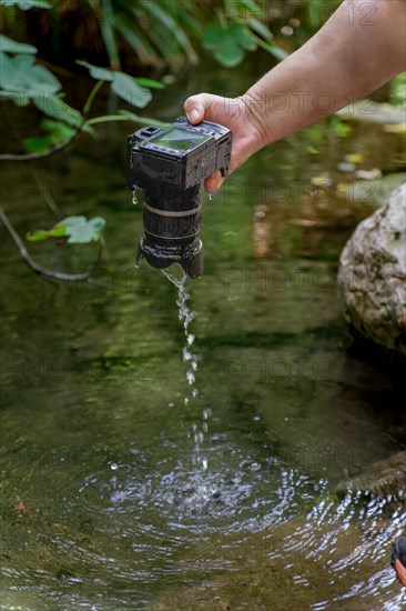 A reflex camera accidentally falls into the river