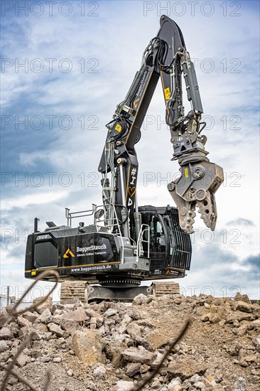 Black Liebherr crawler excavator recycling on demolition site