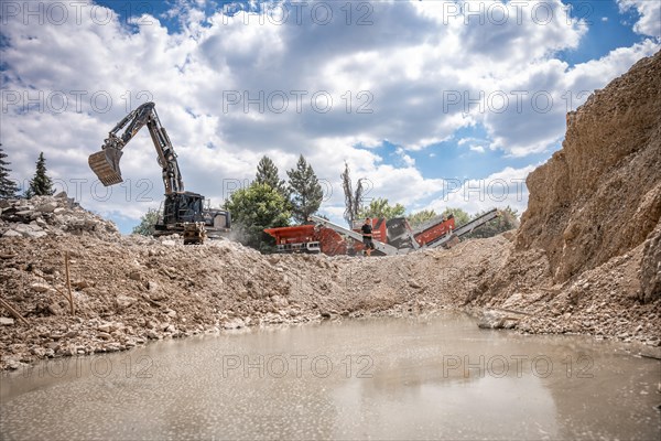 Demolition site with chain excavator and crusher