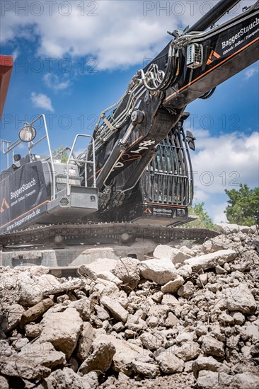 Black Liebherr crawler excavator for demolition recycling on construction site