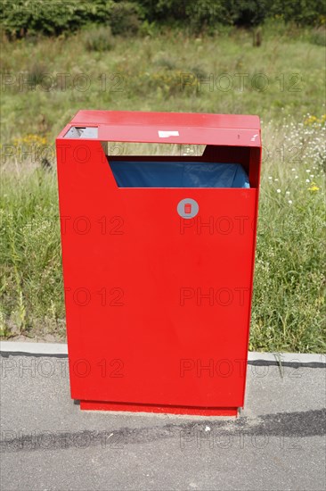 Red metal public waste bin