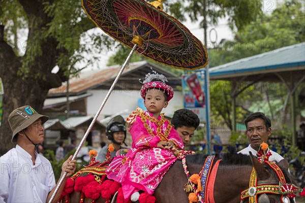 Traditional parade for Burmese child becoming a novice monk in the city Bagan