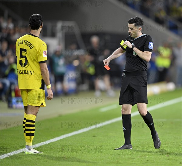 Referee Florian Badstuebner shows Ramy Bensebaini Borussia Dortmund BVB