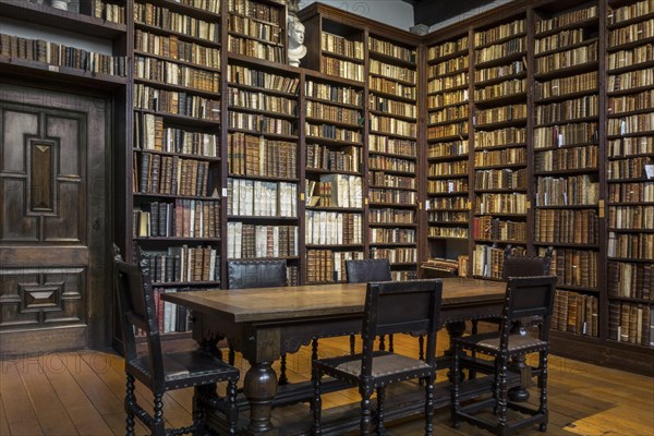Bookshelves with old books in the Small Library at the Plantin-Moretus Museum