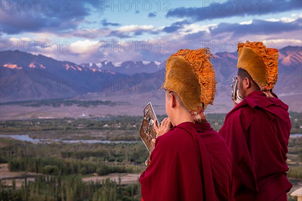 Monks blowing conches at Spituk Monastery