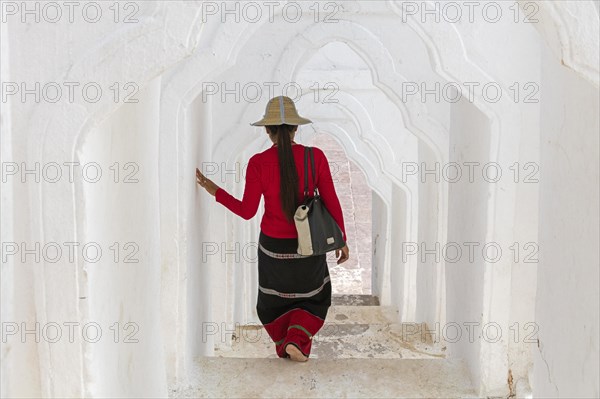 Burmese woman descending stairs in the Hsinbyume pagoda