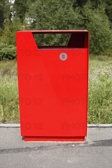 Red metal public waste bin