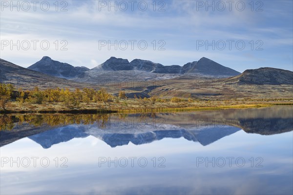 The mountains Hogronden and Digerronden reflected in the water of a lake