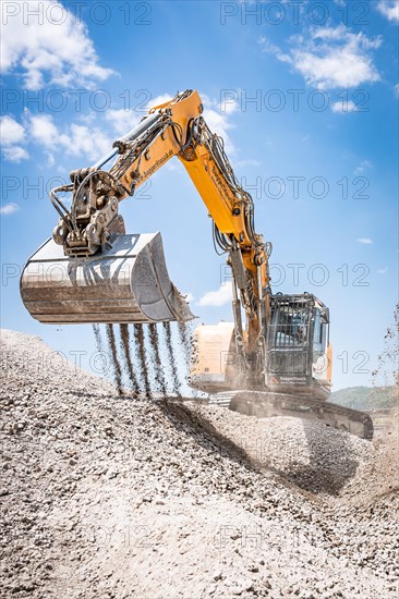 Yellow Liebherr crawler excavator recycling on demolition site