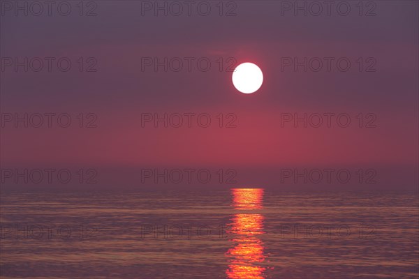 Seascape showing orange sunset over the Wadden Sea