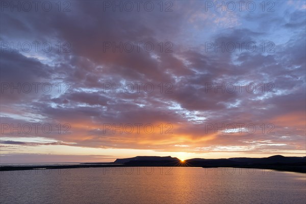 Rain clouds at sunset over lake Prestholalon