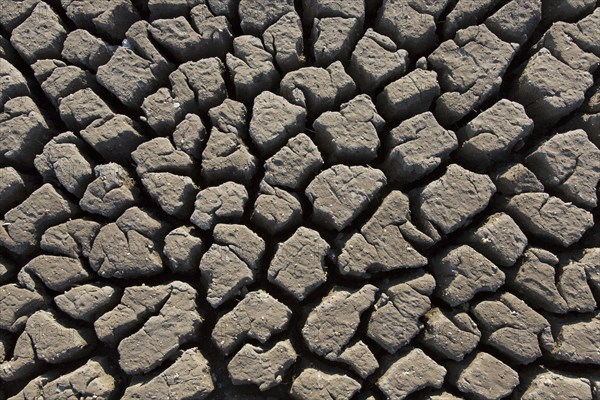 Abstract pattern of dry cracked clay mud in dried up lake bed