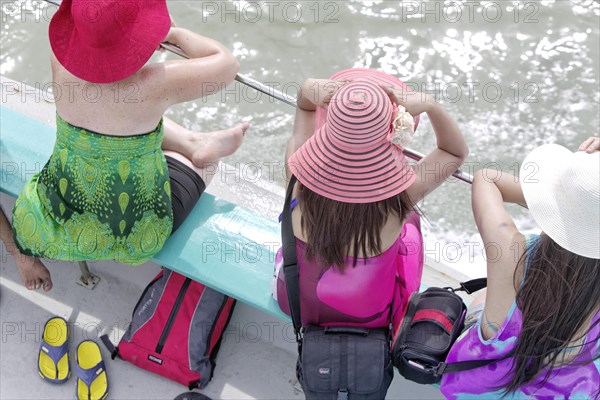 Female tourists with colourful sun hats