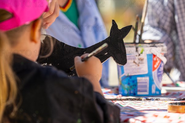 Child painting donkey