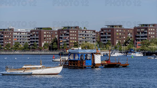 Illegally anchored houseboats in the Rummelsburg Bay with the residential houses on the Rummelsburg shore