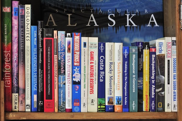 Collection of travel guides about worlwide holiday destinations on a bookshelf