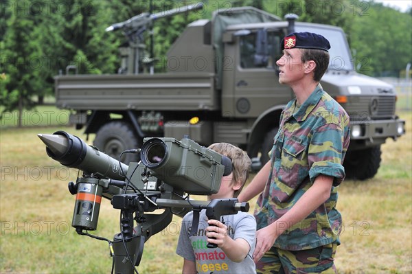 Soldier showing Mistral Air Defence Missile System to child during open day of the Belgian army at Leopoldsburg