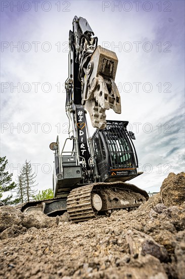 Black Liebherr crawler excavator recycling on demolition site