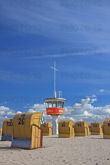 Lifeguard tower and roofed wicker beach chairs on the beach at Travemuende