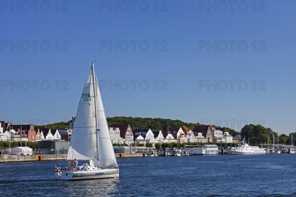 Sailing boat on the river Trave in front of Vorderreihe at Travemuende