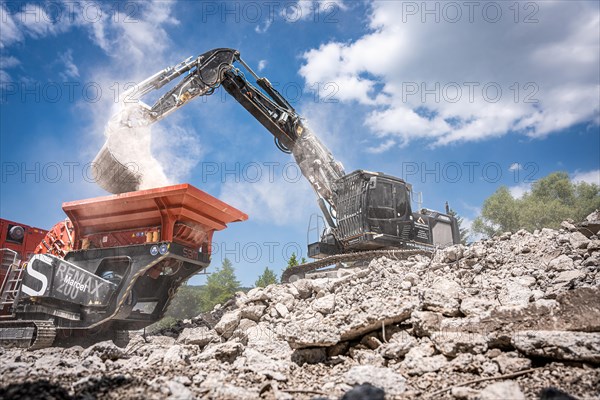 Black Liebherr crawler excavator recycling on demolition site