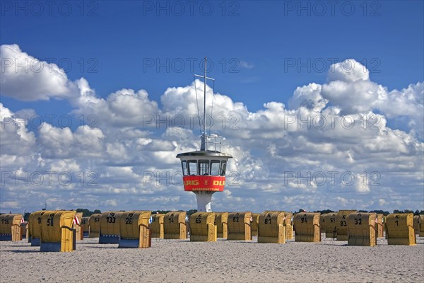 Lifeguard tower and roofed wicker beach chairs on the beach at Travemuende