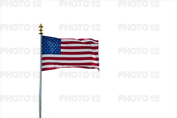 American flag showing US Stars and Stripes blowing in the wind on white background