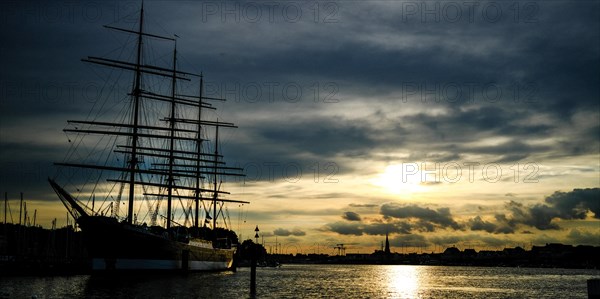 Museum sailing ship Passat in Priewall harbour at sunset