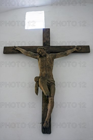 Large wooden crucifix of Christ with charred feet in the chapel of the Chateau d'Hougoumont
