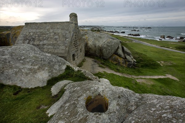 Old customs house wedged between the rocks at Menez Ham