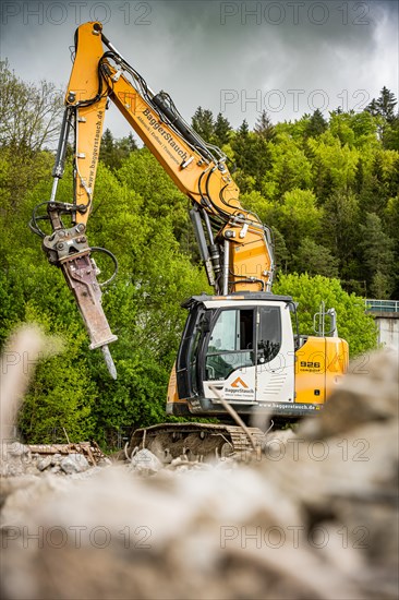 Yellow Liebherr crawler excavator recycling on demolition site