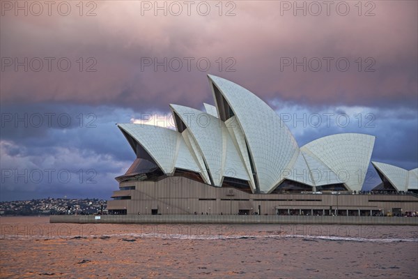 Heavy rain clouds and approaching thunderstorm over the Sydney Opera House at sunset