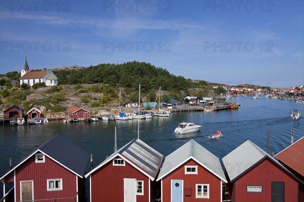 Red wooden boat huts in the harbour at Hamburgsund