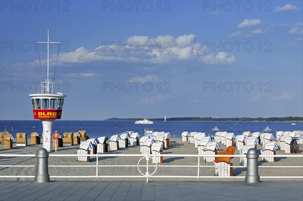 Lifeguard tower and roofed wicker beach chairs on the beach at Travemuende