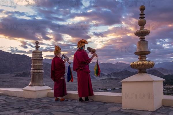 Monks blowing conches at Spituk Monastery