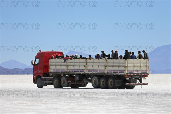 Truck with school children on the salt flat Salar de Uyuni