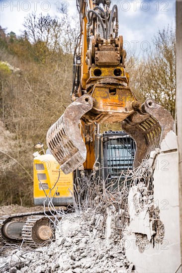 Yellow Liebherr crawler excavator recycling on demolition site