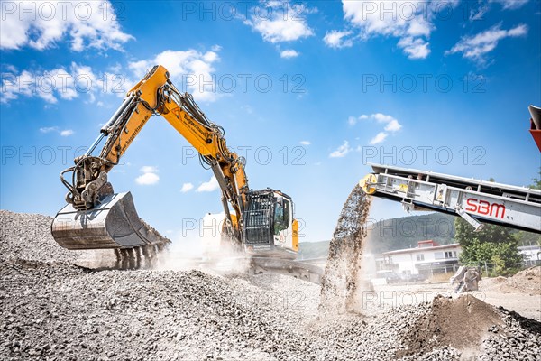 Yellow Liebherr crawler excavator recycling on demolition site