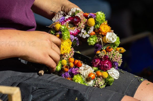 Florist weaving dried flower wreath