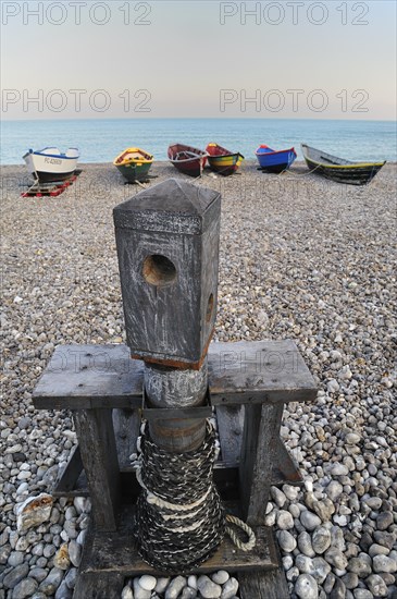 Old capstan and colourful traditional caiques