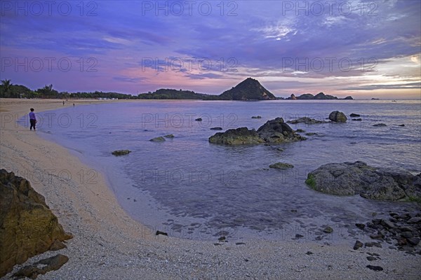 Tourists on Kuta beach at sunset on the island Lombok