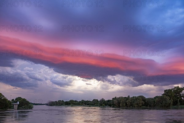 Thunderstorm building at sunset over the Orange river near Upington