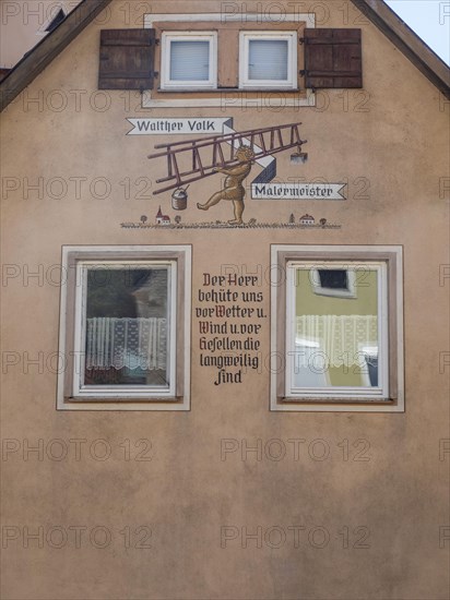 Fresco with motto on house facade