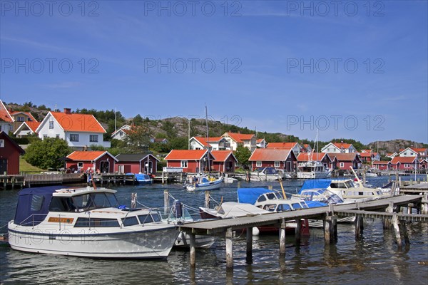 Red wooden boat huts in the harbour at Hamburgsund