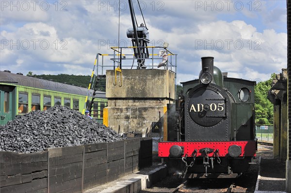 Crane loading coal as fuel for steam train at the depot of the Chemin de Fer a Vapeur des Trois Vallees at Mariembourg