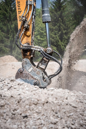 Shovel of an excavator in the ground on construction site