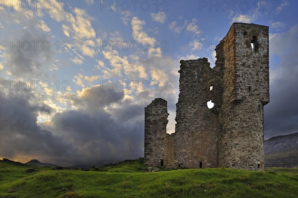 The 16th century Ardvreck Castle ruins at Loch Assynt in the Highlands at sunset