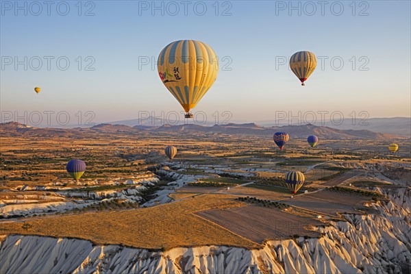 Hot air balloons flying over Cappadocia at sunrise