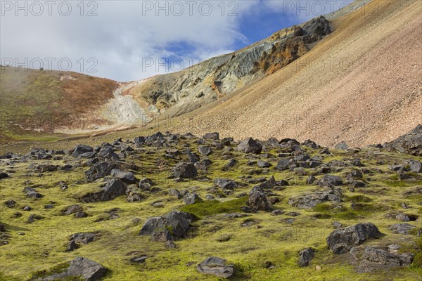 Lava field and sulphur coloured rhyolite mountains at Brennisteinsalda volcano near Landmannalaugar
